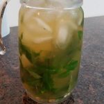 Glass pitcher containing the finished mixed herbal drink.