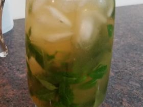 Glass pitcher containing the finished mixed herbal drink.